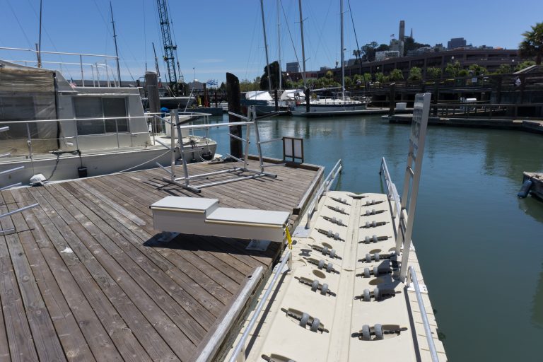 Accessible kayak launch next to wooden pier leading to motorized accessible lift